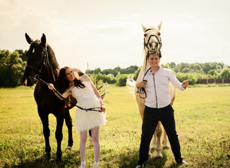 wedding of unusual couple happy near horses